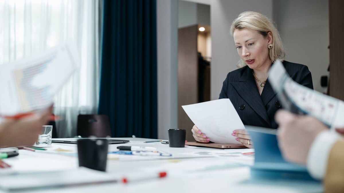 Manager reviewing a renewal document at a conference table