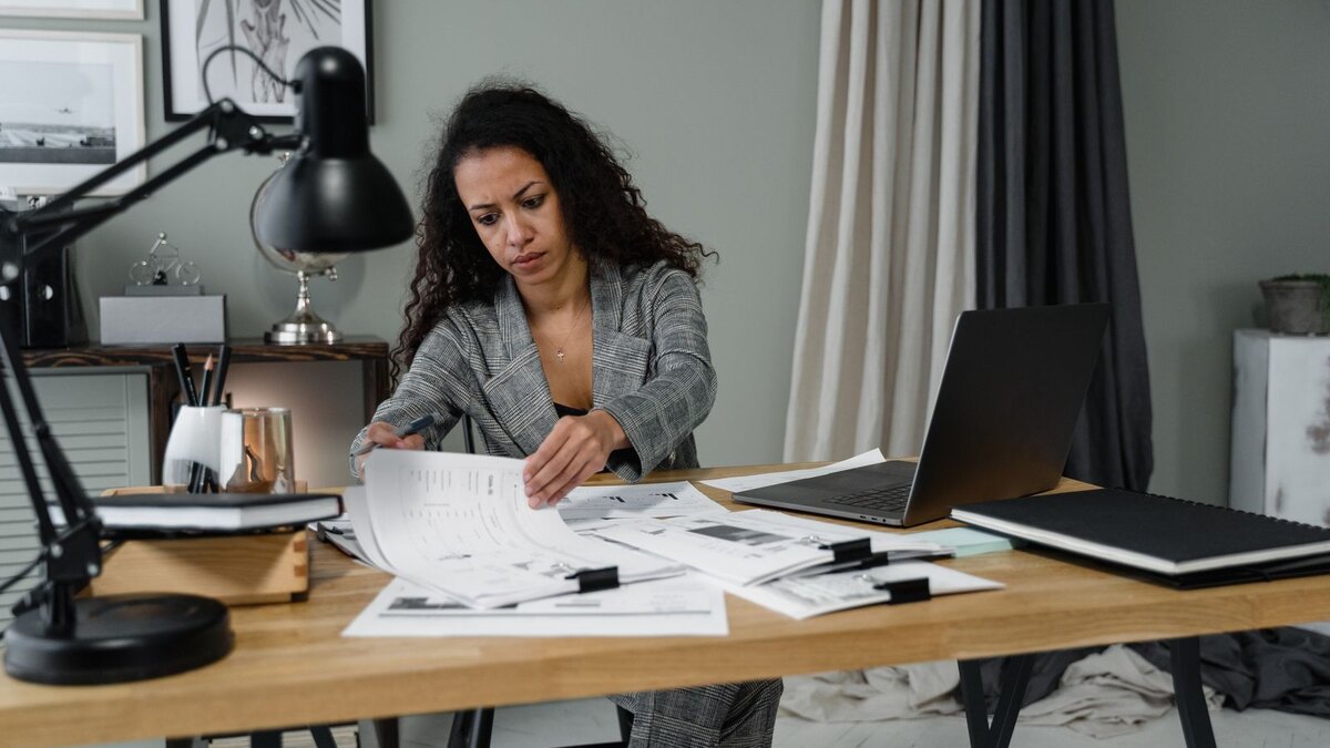 Operations lead sorting training files across a desk
